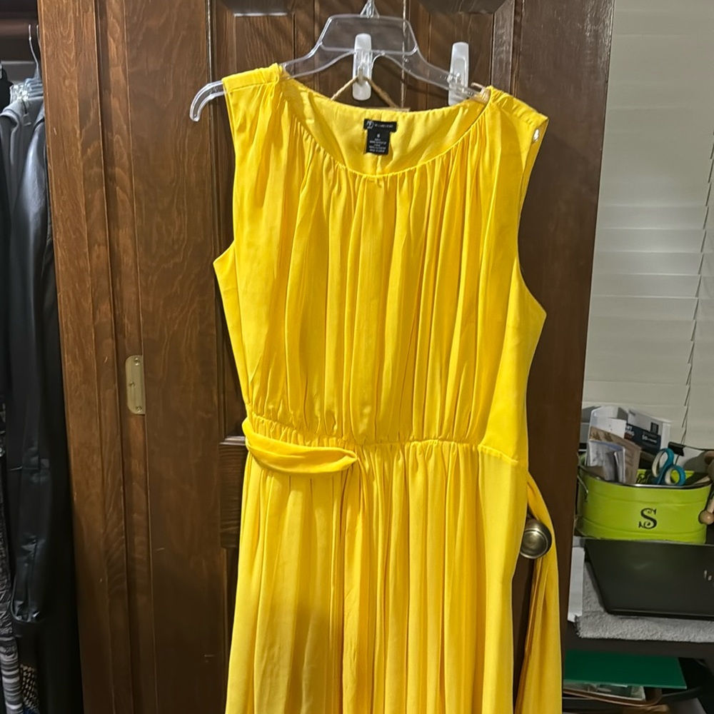 Yellow flowy sleeveless dress. Knee length.